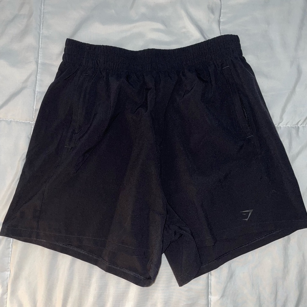 Black Gymshark high-waisted woven shorts with zippered pockets